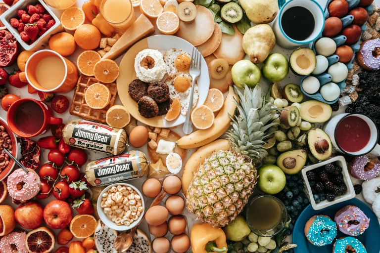 A comparison of fresh fruits and vegetables beside packaged ultra-processed foods, illustrating the impact of diet on healthy ageing.