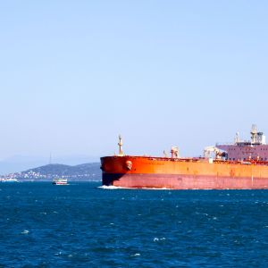 Oil tanker transiting the Strait of Hormuz under heightened naval security during rising regional tensions.